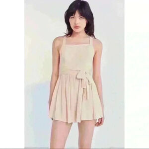 NWT Tan romper with a criss crossed open back